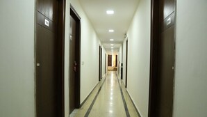 A long, narrow hallway with doors on both sides, numbered 101 and 110. - OYO Rooms 486 IGI Airport Near Main Road (New Delhi)