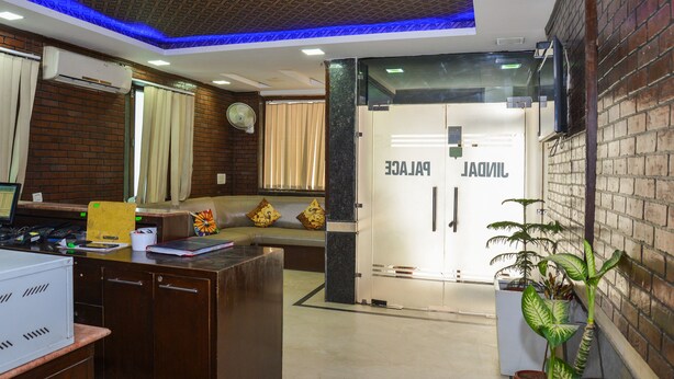 A reception area with a desk, a seating area, and a glass door labeled "PALACE." - OYO Rooms 486 IGI Airport Near Main Road (New Delhi)