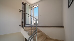 A staircase with a metal railing, leading to an open door. - Holiday Home "Vista Mare Marittima di Diso" with Terrace & Wi-Fi (Marittima)