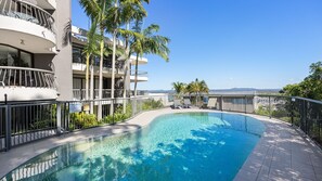 Enjoy a refreshing swim in our pool surrounded by lush palm trees and breathtaking mountain views.