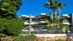 Experience the unique architecture and serene surroundings of this hotel, featuring rounded balconies and lush greenery.