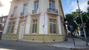 A historic building with ornate architectural details, including decorative balconies and a classic facade. - Casa Marina Huérfanos (Santiago)