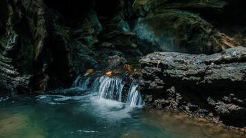 A natural rock formation with a small waterfall.