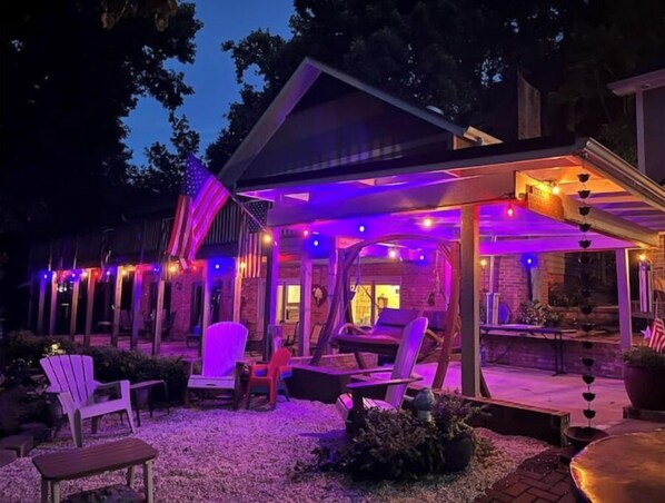 Relax and dine in style on this patio, complete with comfortable seating and a dining table.