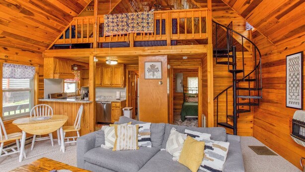 A spacious cabin with a loft bedroom, a dining area, and a kitchen. - Serenity Wood- The place for daytime outdoor adventures & cozy nights  (Blue Ridge)