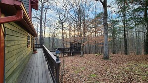 A wooden deck with a gazebo, surrounded by a forest with autumn leaves. - Serenity Wood- The place for daytime outdoor adventures & cozy nights  (Blue Ridge)