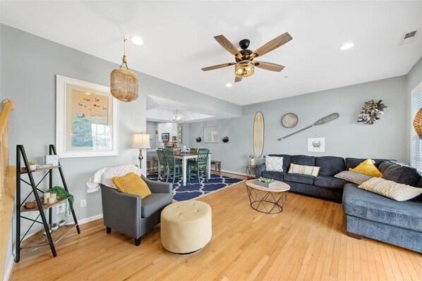 Relax in this stylish living room with a sofa, ottoman, and coffee table, perfect for unwinding.