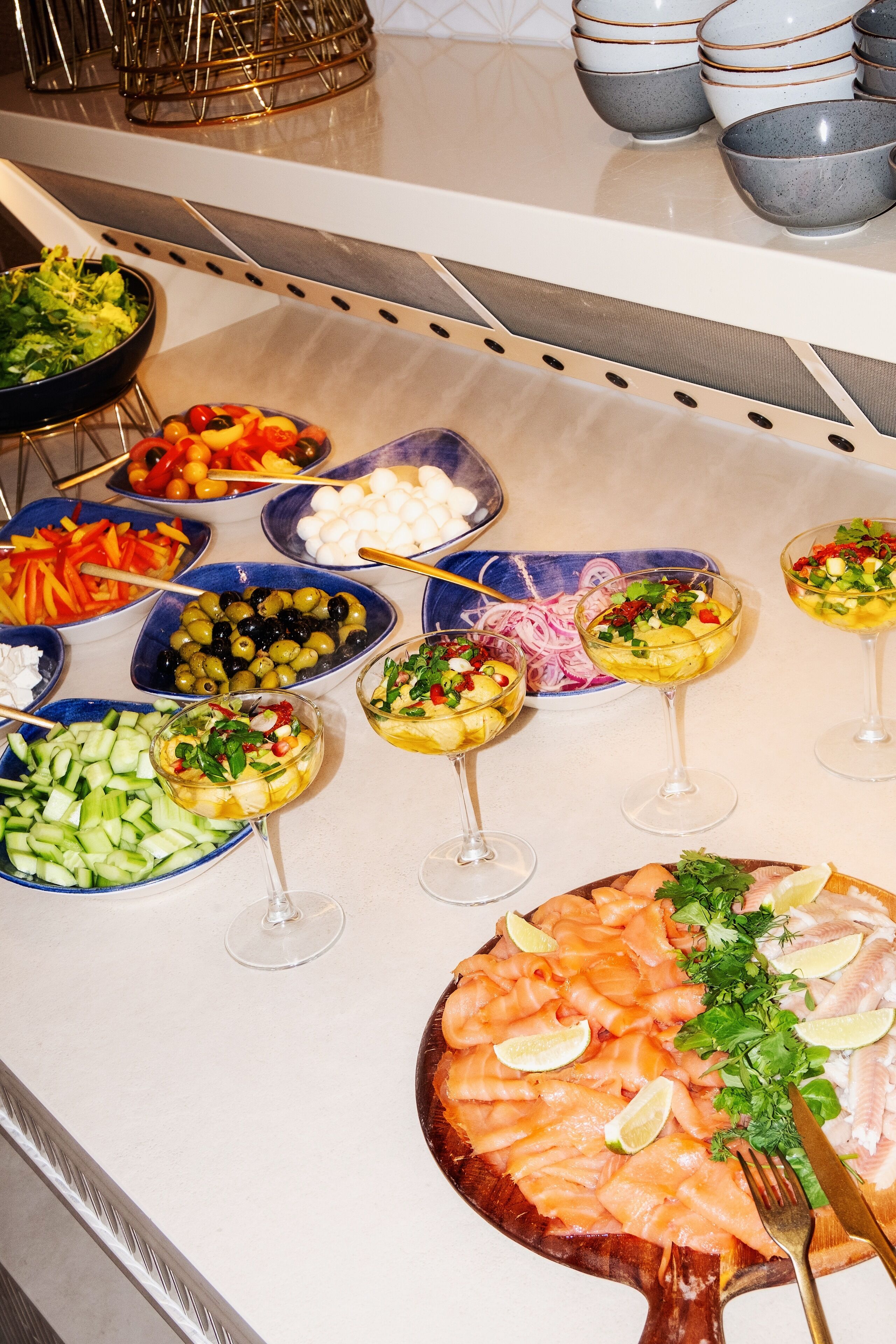 A buffet with various dishes and drinks.