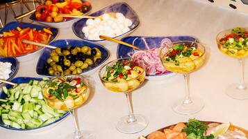 A buffet with various dishes and drinks.