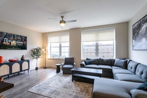 Relax in this inviting living space with a large sofa, coffee table, and side table.