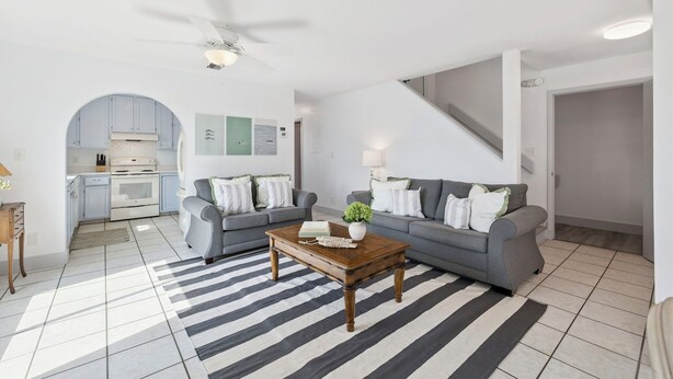 A modern living room with a grey sofa, a wooden coffee table, and a striped rug. - Inlet Beach Dream - East 30A, Gulf View, Near Shops + Dining, Steps to the Sand! (Inlet Beach)