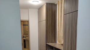 A narrow hallway with wooden flooring and built-in wardrobes. - Addis Hill  (Addis Ababa)