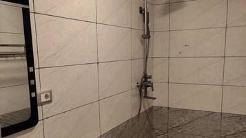 A bathroom with a sink, toilet, and shower.