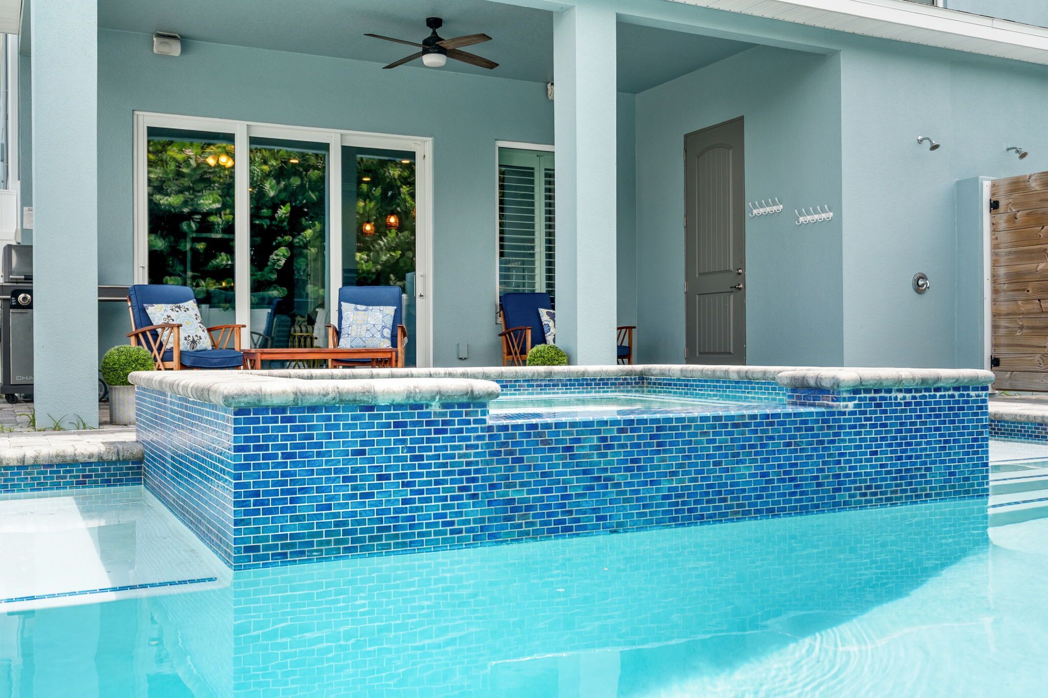 Beach Haven boasts an oversized hot tub with a waterfall feature into the pool. The perfect spot to relax and unwind.
