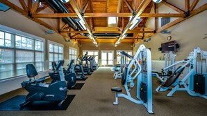 A gym with exercise equipment, large windows, and a high wooden ceiling. - 🏖️ Spectacular and Spacious Townhouse in Resort Community (Berlin)