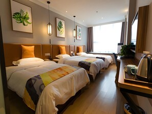 A hotel room with two beds, a desk with a coffee maker, and artwork on the walls. - Shell Zhengzhou Zhongyuan Fota Hotel (Zhengzhou)