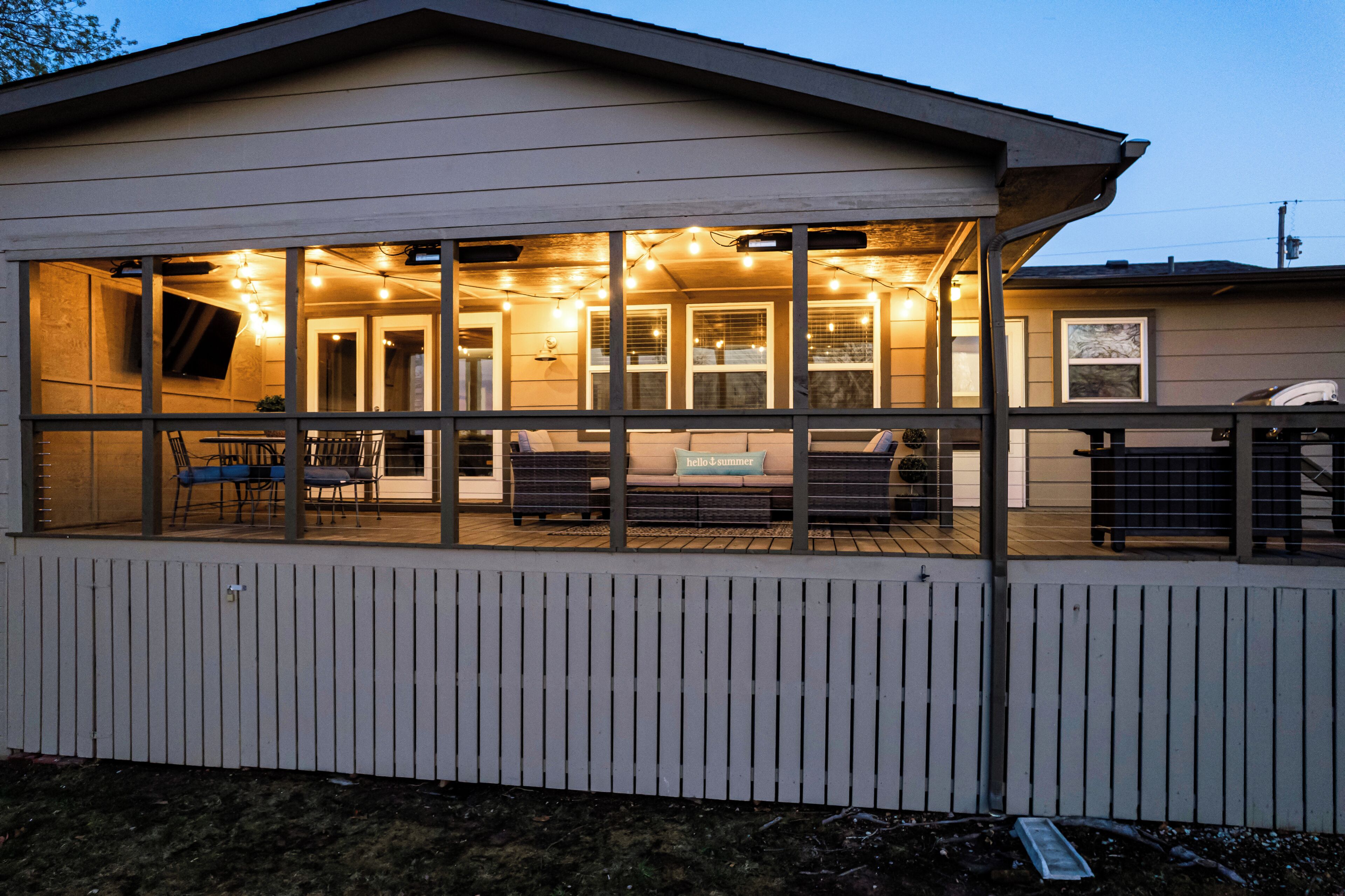 A covered outdoor area with a seating arrangement and a view of the interior.