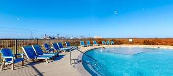 Modern, second-floor condo steps to beach with balcony, W/D, & pool access