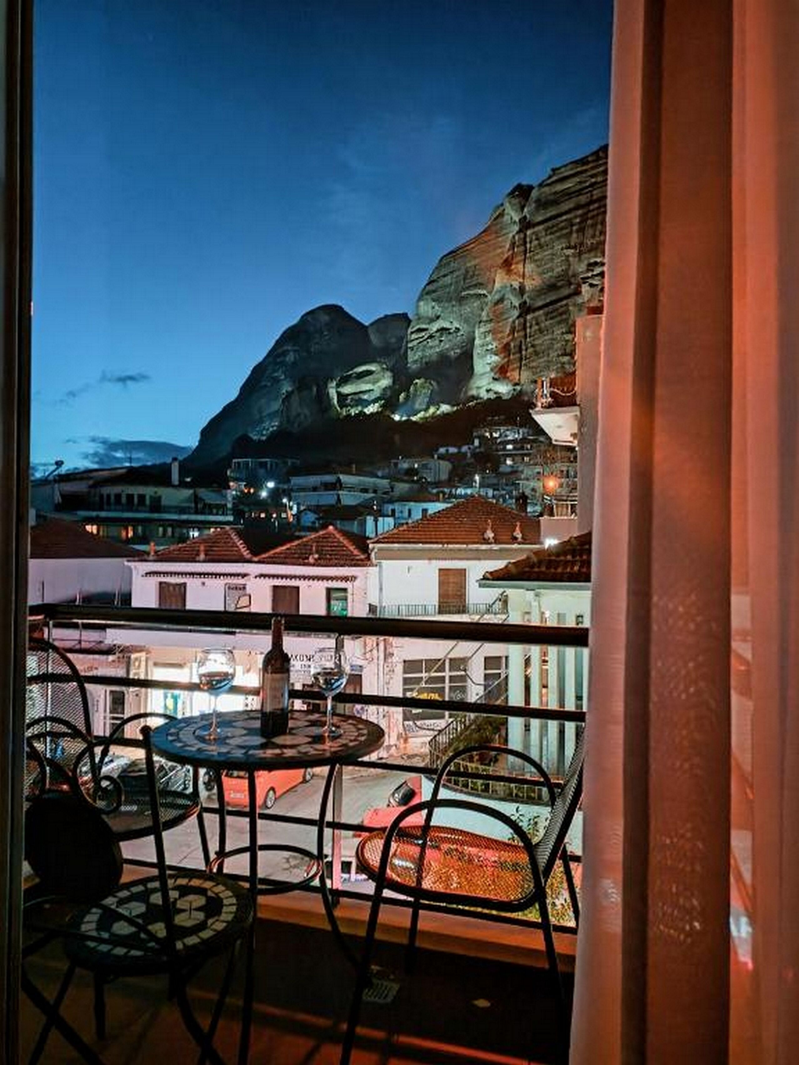 Un balcón con vista a una montaña y edificios.