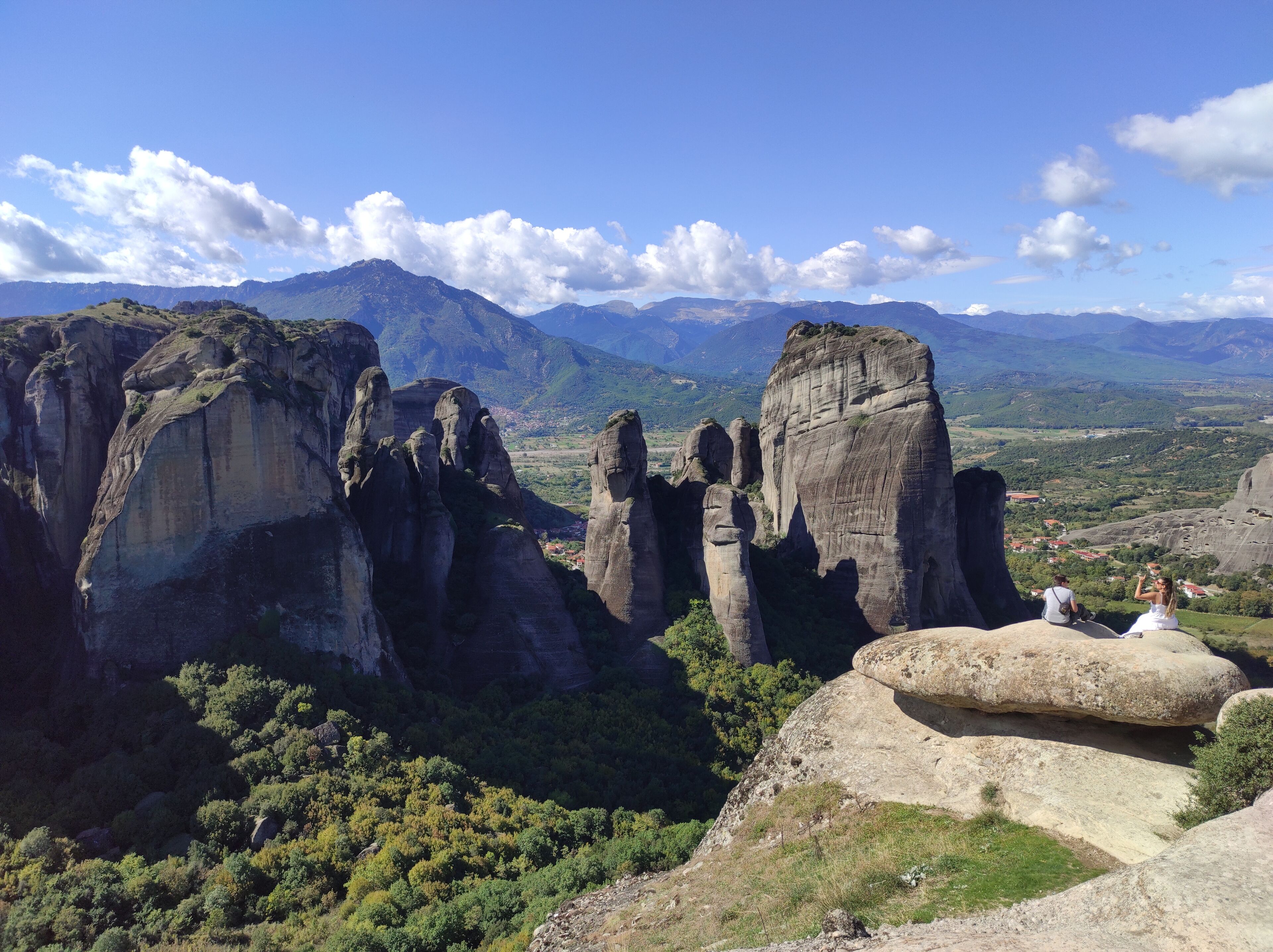A mountainous landscape with prominent rock formations and a valley below.