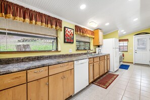 Fully equipped kitchen with a dishwasher, refrigerator, and washing machine.