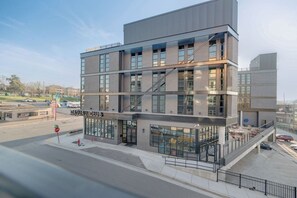 A multi-story building with a ground-level commercial space labeled 'CASUAL CLUB.'