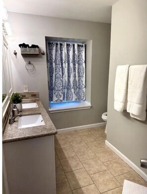 A bathroom with two sinks, a window with patterned curtains, and a towel rack. - Spacious 3 BDRM for 9 - SA & NB (Live Oak)