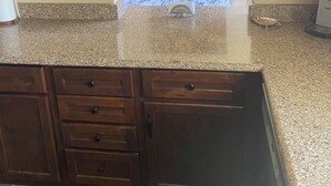 A kitchen with wooden cabinets, granite countertops, and a marble backsplash. - Country Home with Pond and Great Outdoor Space (Nashport)
