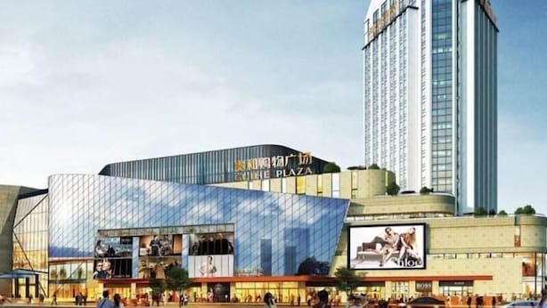 A modern building with a curved glass facade and a prominent sign reading "COHEN PLAZA". - Greentree Inn Jining Jinyu Road Red Star Macalline Express Hotel (Jining)
