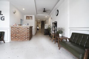 A hotel lobby with a reception desk, a green sofa, a dining area, and a staircase in the background. - M S Hotel Tengku Kelana KTM Klang (Klang)