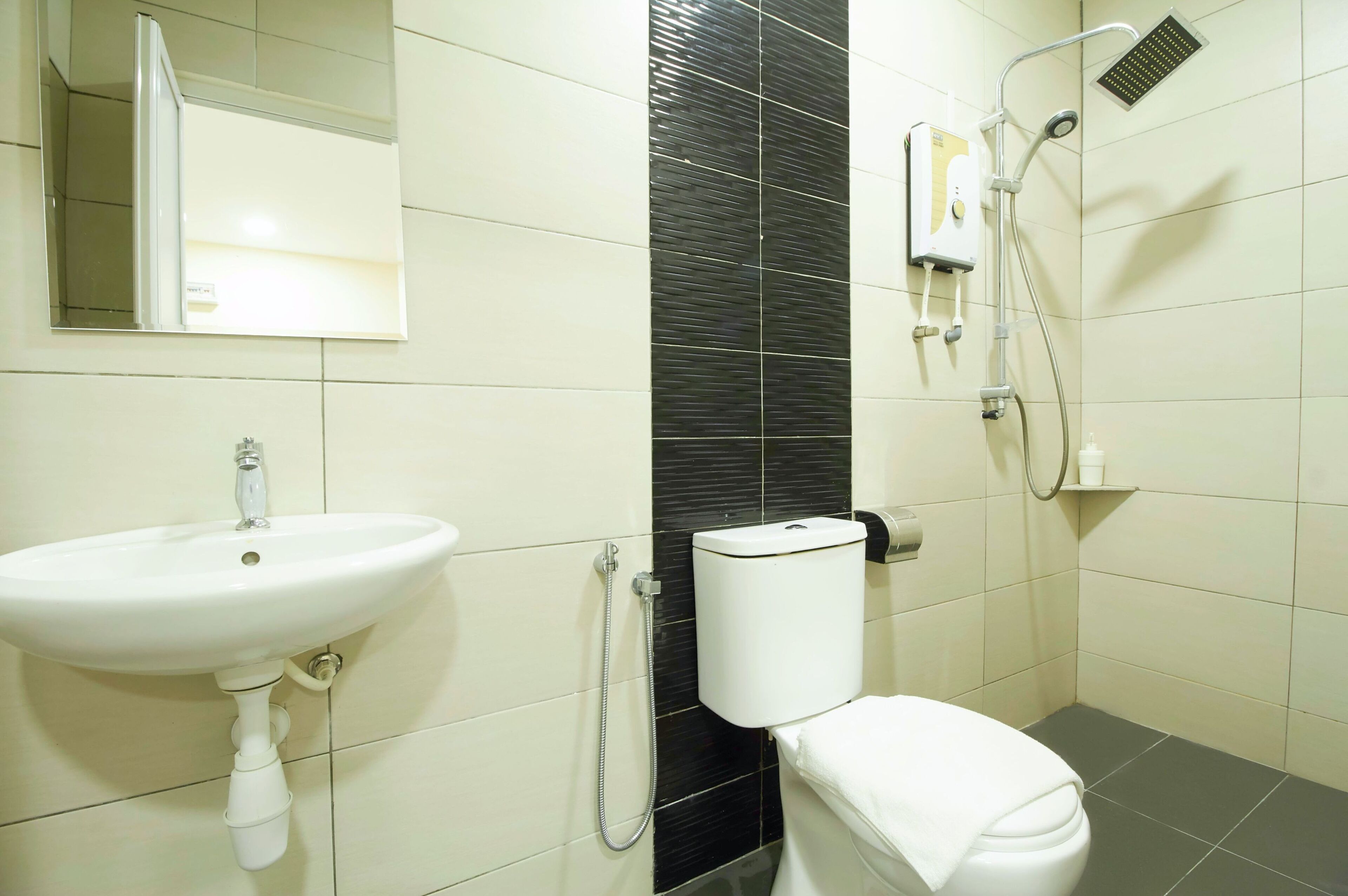 A bathroom with a white sink, toilet, and shower.