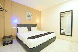 A neatly made bed with white linens, a dark headboard, and a bedside table with a book. - M S Hotel Tengku Kelana KTM Klang (Klang)