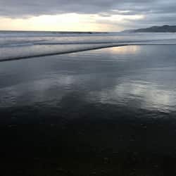 On the beach, black sand