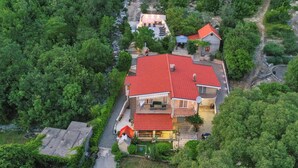 A large house with a red roof, surrounded by dense greenery. - Lovely home in Vrgorac (Vrgorac)