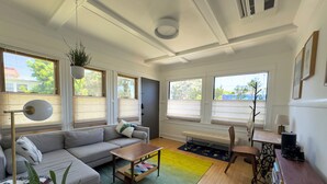 A modern living room with a sofa, coffee table, and a bookshelf. - Historic & sunny beachside 2br with modern comforts (Marina del Rey)