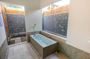 Separate bathtub and shower, towels
