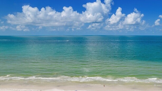 Una playa con agua turquesa cristalina y una orilla arenosa.