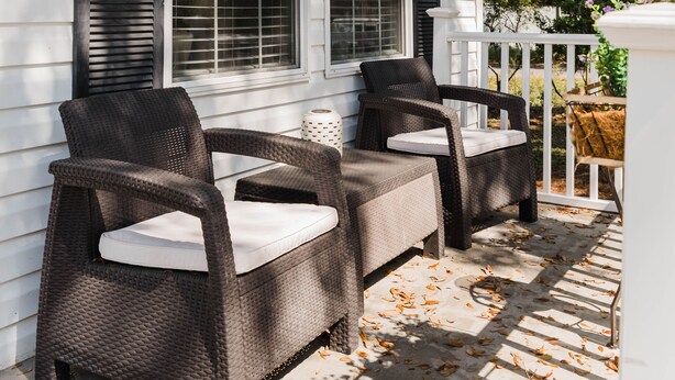 A porch with wicker furniture and a white railing. - Beautiful Cottage-Style Home Minutes From Downtown Charleston! (Charleston)
