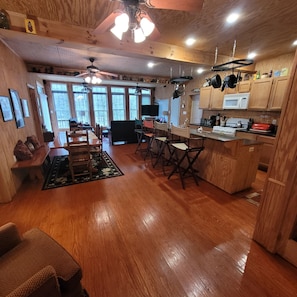 Enjoy cooking and dining in this well-equipped kitchen with a central island, microwave, stove, and dining area.