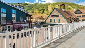 A building with a sign reading "Park City" and a view of a hilly landscape in the background. - Resort Plaza Condominiums 5030 - 5064 (Park City)