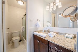 A bathroom with a toilet, sink, and mirror. - Resort Plaza Condominiums 5002-5025 (Park City)