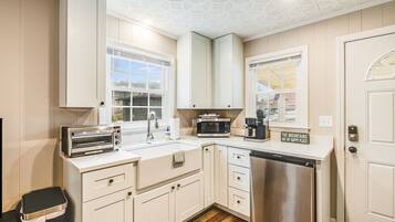 Fridge, microwave, coffee/tea maker, cookware/dishes/utensils