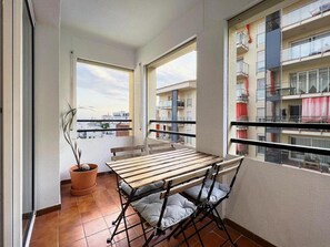Enjoy a peaceful retreat with a balcony featuring a table and chairs, perfect for taking in the views of the surrounding neighborhood.