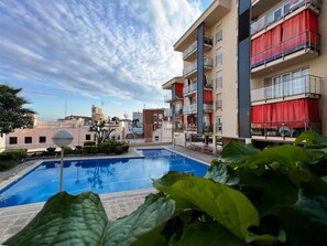 Enjoy a refreshing swim at the rooftop pool surrounded by a spacious deck and stunning views.