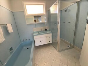 Bathtub, hair dryer, towels, soap