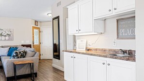 A modern kitchen with white cabinets, a granite countertop, and a stainless steel sink. - Private home near Zion & state parks, BBQ, cozy stay for family & friends in scenic red rock views! (La Verkin)