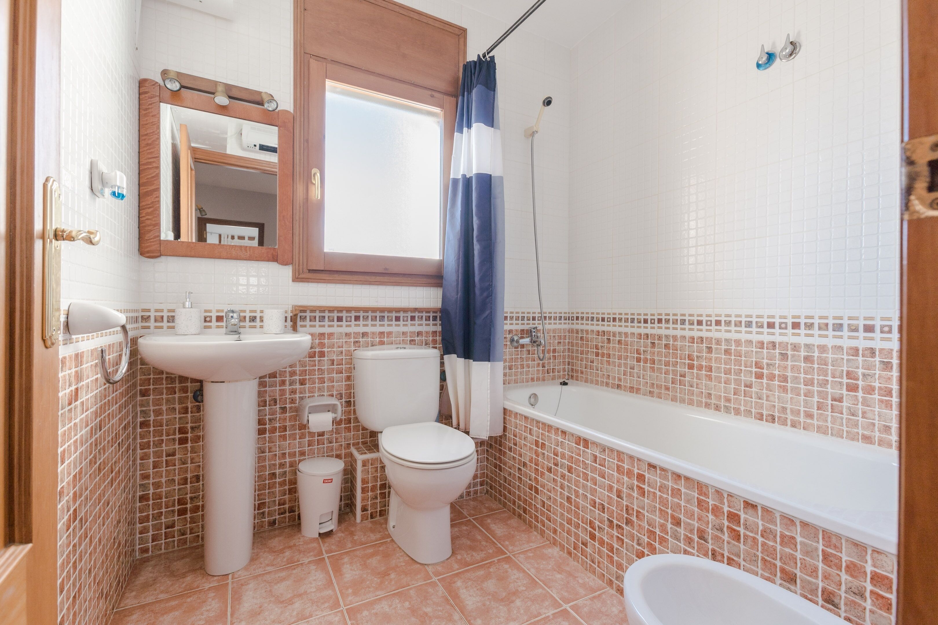 A bathroom with a sink, toilet, and bathtub.