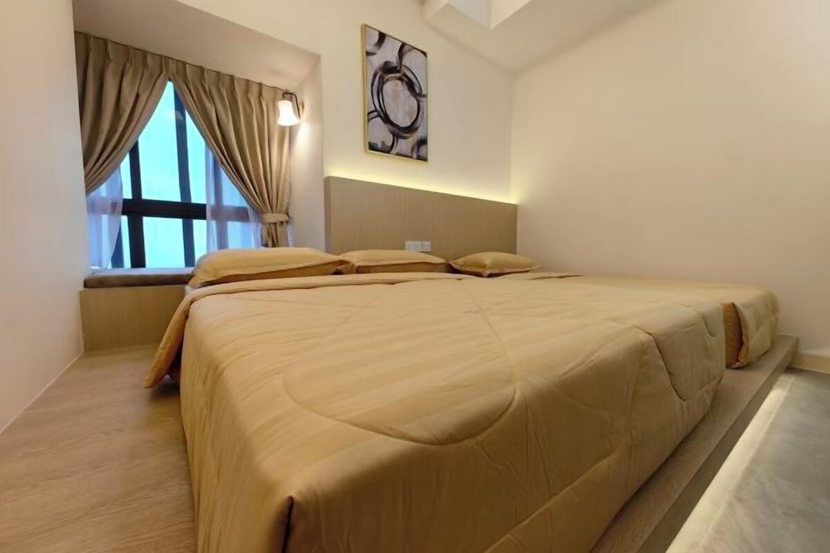A bedroom with a large bed, a window with curtains, and a wall-mounted abstract art piece.