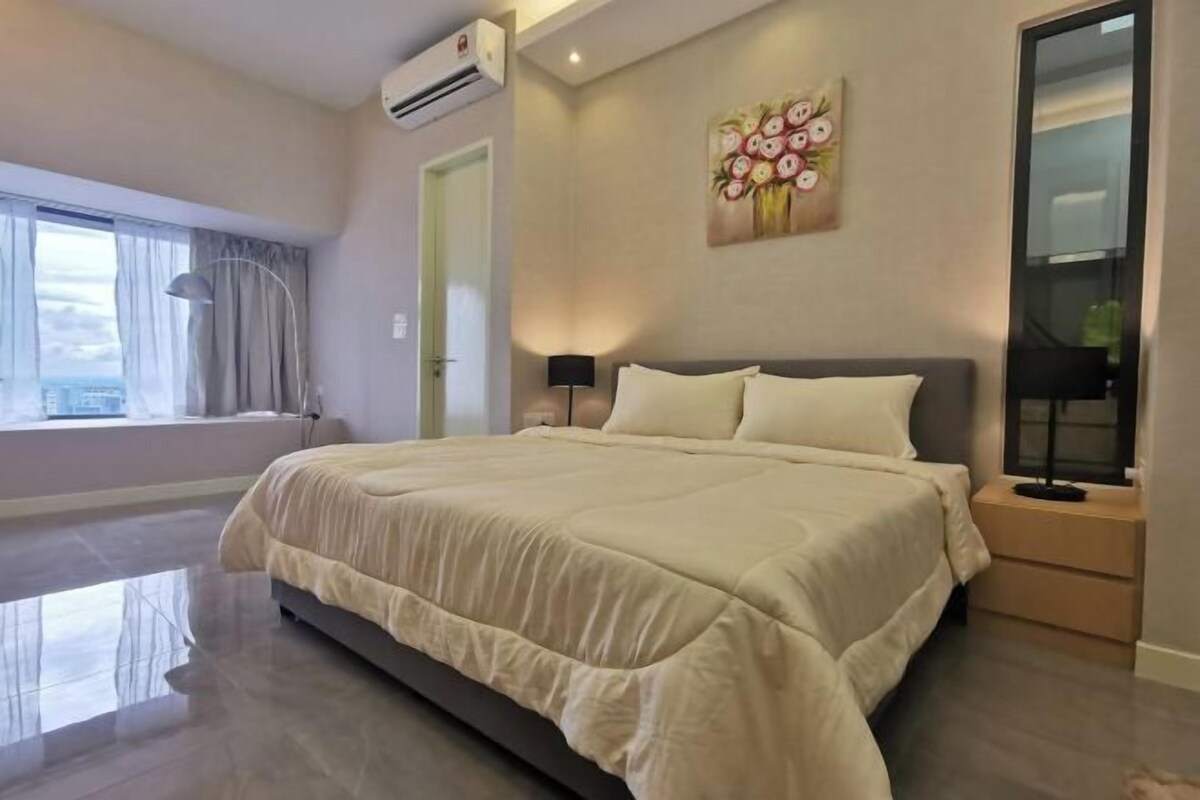 A modern bedroom with a large bed, a bedside table, a nightstand, a window with curtains, and a wall-mounted air conditioner.