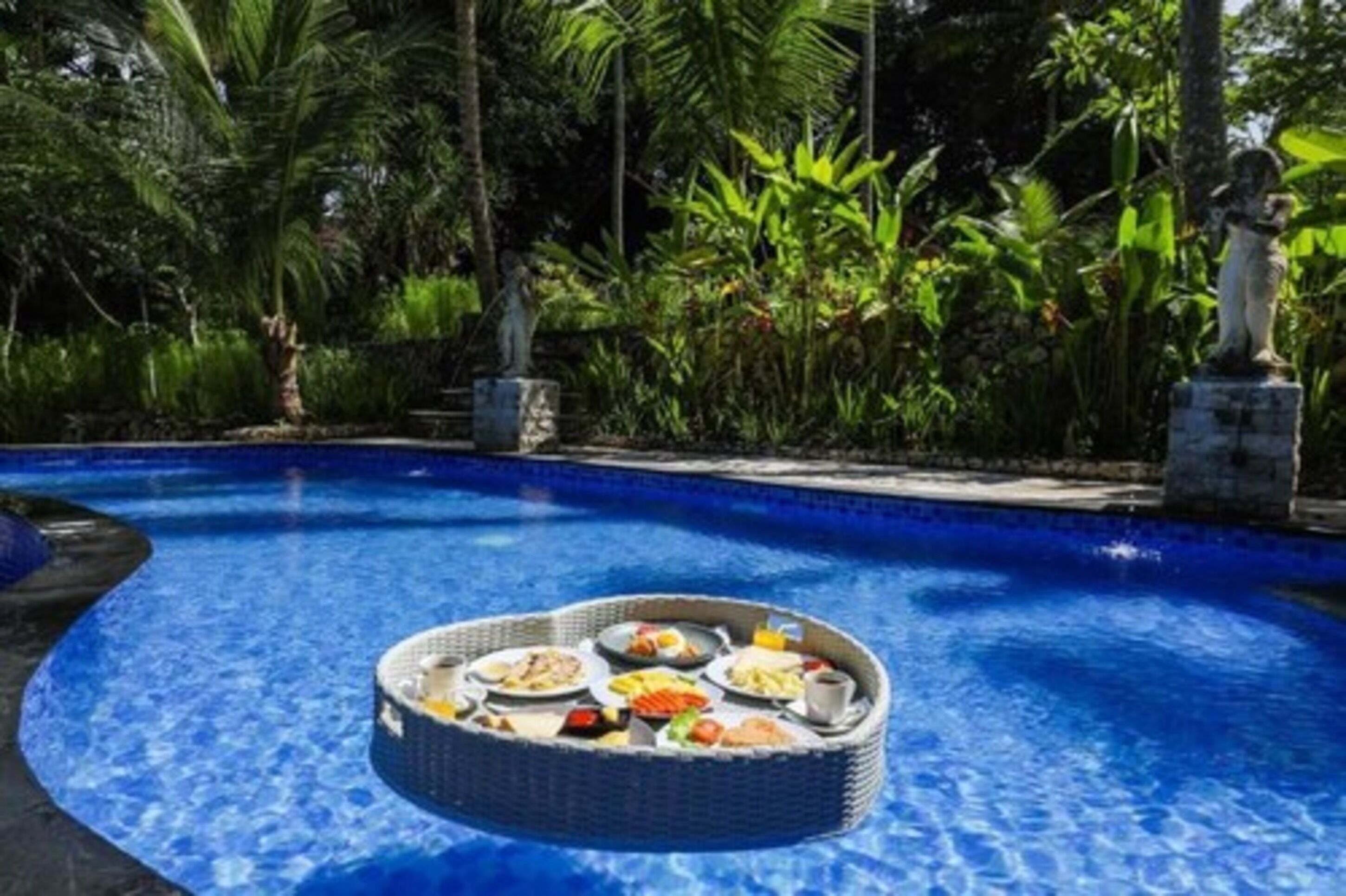 A poolside breakfast setup with a tray of food.